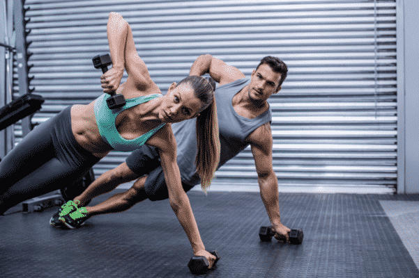 Man And Woman Work Out At A Gym
