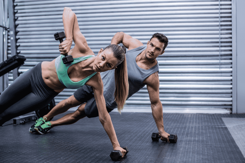 Man and Woman Work Out At A Gym